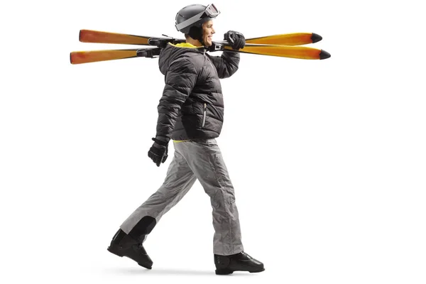 Full Length Profile Shot Man Skiing Boots Walking Carrying Skis — Stok fotoğraf