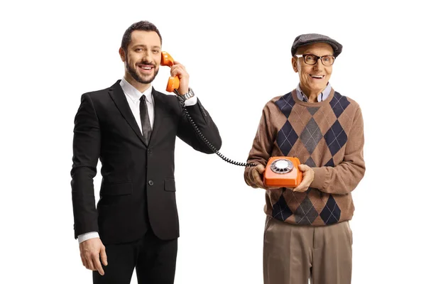 Elderly Man Holding Vintage Rotary Phone Young Man Talking Isolated — Foto Stock