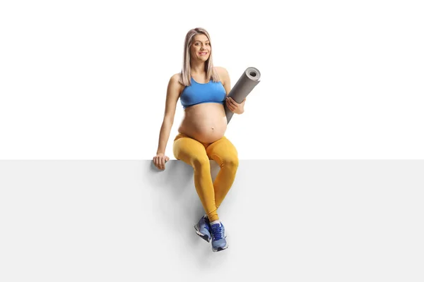 Full Length Portrait Pregnant Woman Sportswear Holding Exercise Mat Sitting — Stockfoto