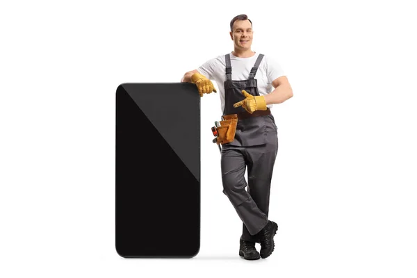 Full Length Portrait Repairman Uniform Leaning Big Mobile Phone Pointing — Photo