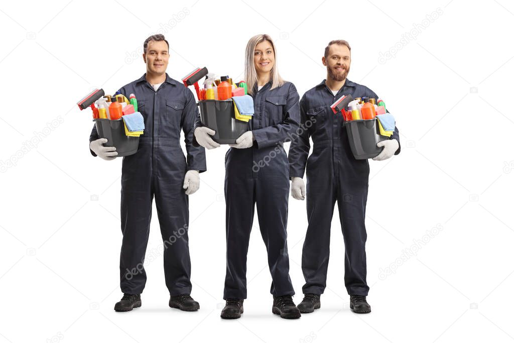 Female and male cleaners in uniforms holding buckets with cleaning supplies isolated on white background