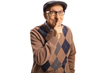 Elderly man smiling and gesturing silence with finger over mouth isolated on white background