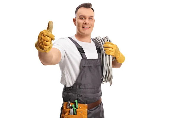 Electrician Carrying Cables His Shoulder Gesturing Thumbs Isolated White Background — Stockfoto