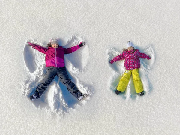 Older Younger Child Making Angels Snow — Stock Photo, Image