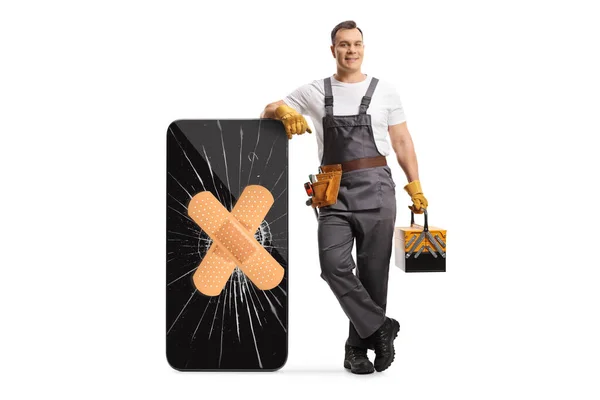 Full Length Portrait Repairman Leaning Smartphone Cracked Screen Adhesive Bandage — Stock Photo, Image