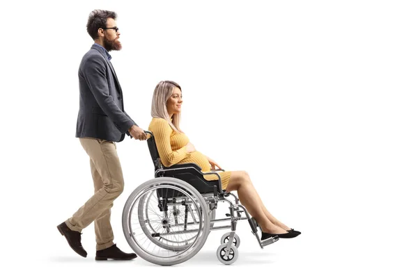 Full Length Profile Shot Man Pushing Pregnant Woman Wheelchair Isolated — Stock Photo, Image