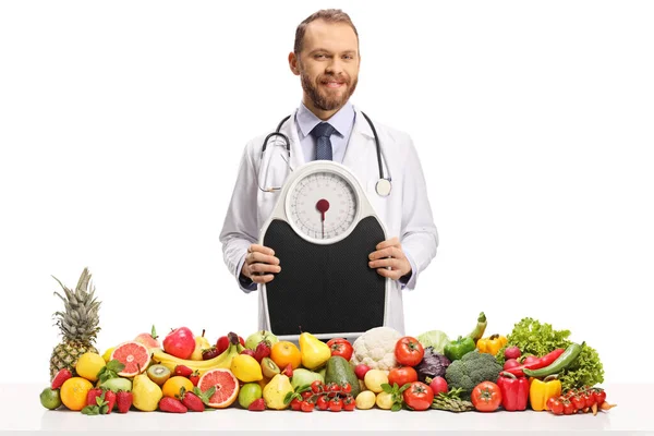 Young Male Doctor Holding Weight Scale Pile Fruits Vegetables Isolated — Stock Photo, Image