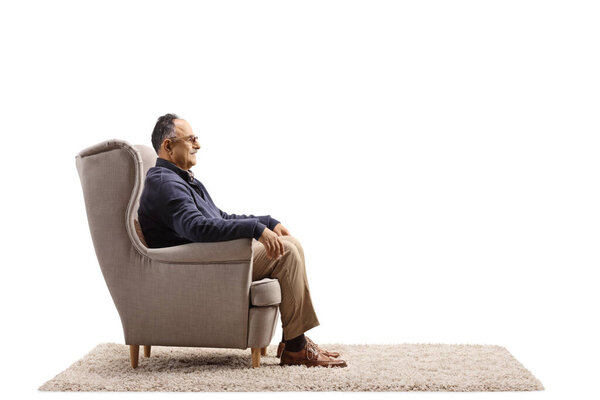 Profile shot of a casual mature man armchair isolated on white background