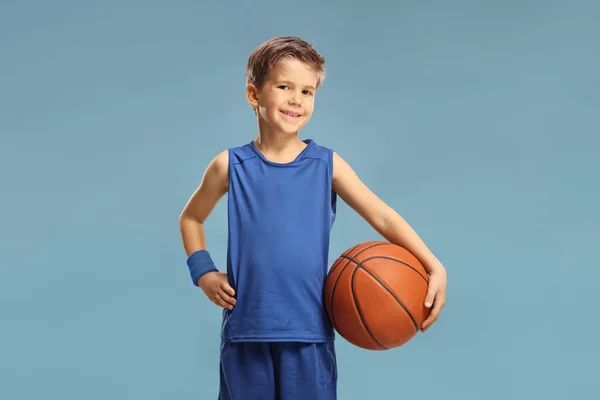 Boy Blue Jersey Holding Basketball Isolated Blue Background — Stok Foto