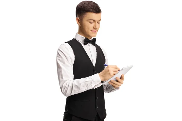 Jovem Servidor Masculino Com Laço Gravata Escrever Uma Ordem Isolada — Fotografia de Stock