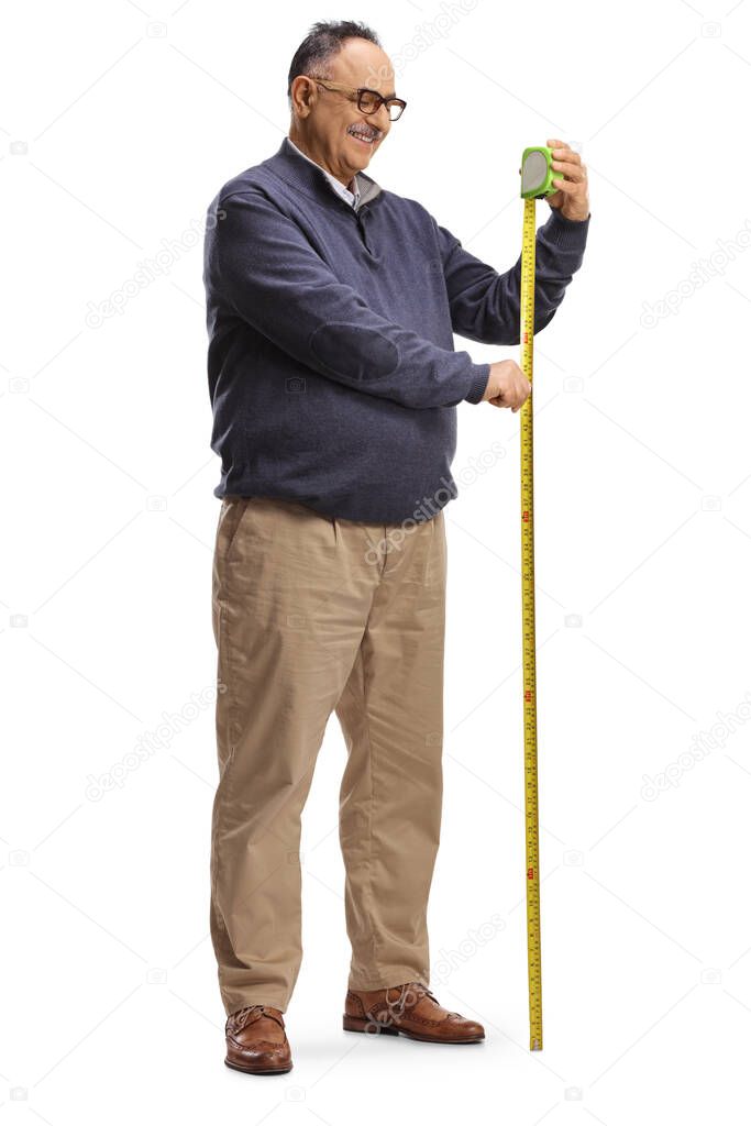 Full length shot of a mature man using a steel tape measure isolated on white background