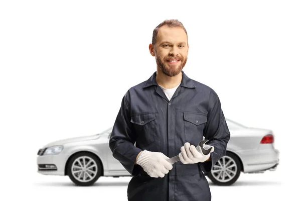 Mechanic Front Silver Car Holding Wrench Smiling Isolated White Background — Stock Photo, Image