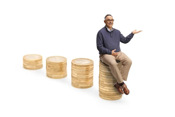 Mature Man Sitting Tallest Pile Coins Showing Hand Isolated White — Stock Photo, Image