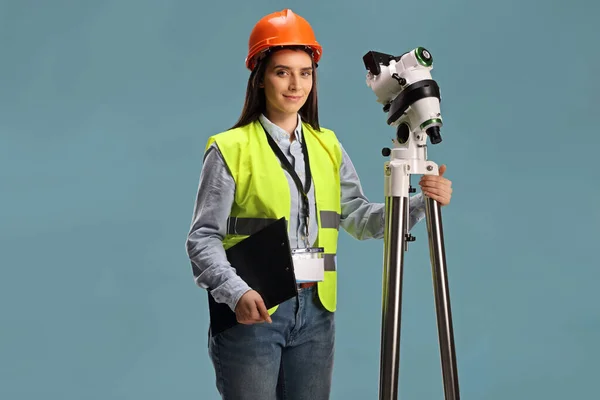 Female Geodetic Surveyor Posing Measuring Instrument Tripod Isolated Blue Background — Stock Photo, Image