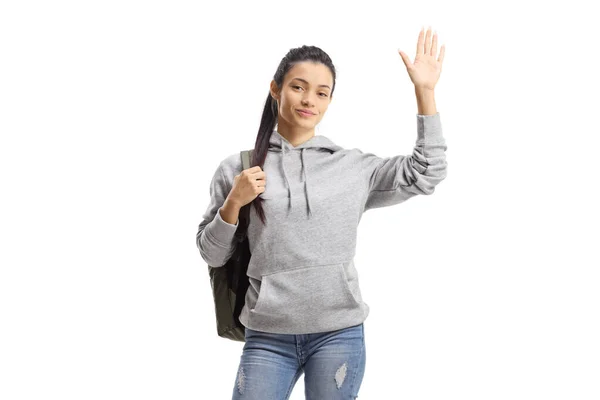 身穿灰色帽衫的女学生在白色背景下被隔离开来挥手 — 图库照片