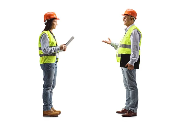 Mature Male Engineer Talking Young Female Engineer Isolated Blue Background — Stock Photo, Image