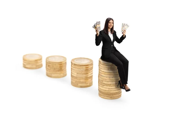 Businesswoman Sitting Pile Coins Holding Banknotes Isolated White Background — Stock Photo, Image