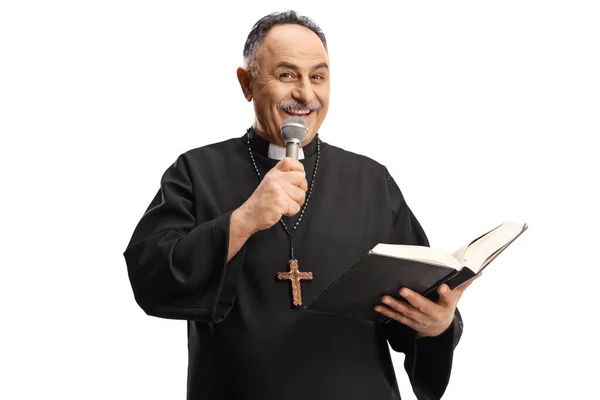 Mature Priest Reading Prayer Bible Holding Microphone Isolated Blue Background — Stock Photo, Image