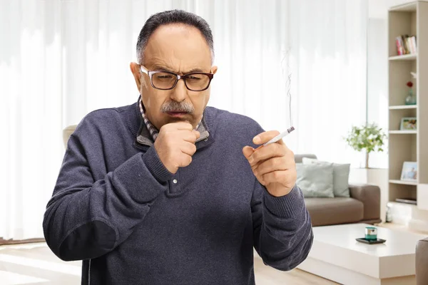 Mature Man Smoking Cigarette Coughing Indoors Apartment — Stock Photo, Image