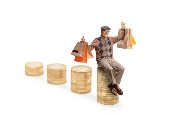 Elderly Man Sitting Pile Coins Holding Shopping Bags Isolated White — Stock Photo, Image
