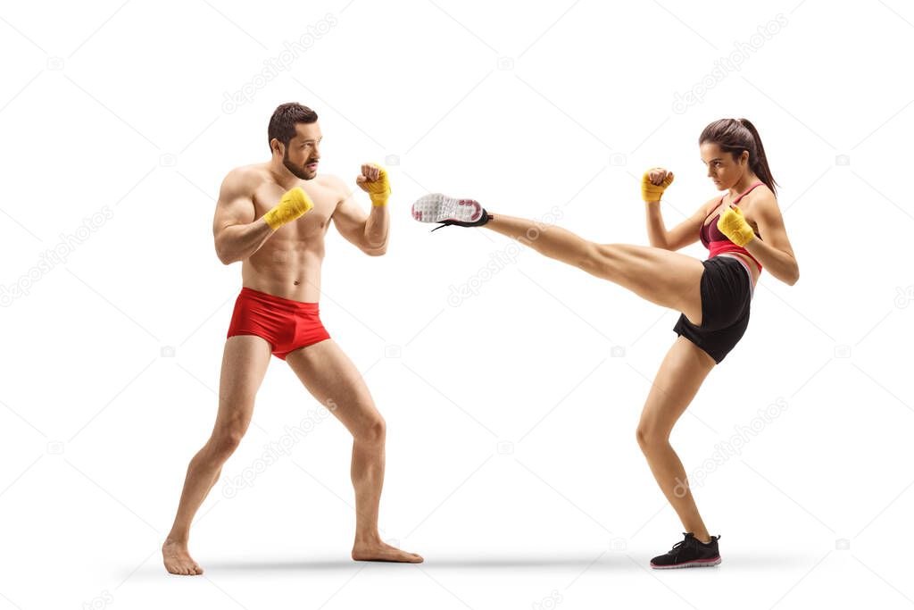 Male and female athlets exercising kick boxing isolated on white background