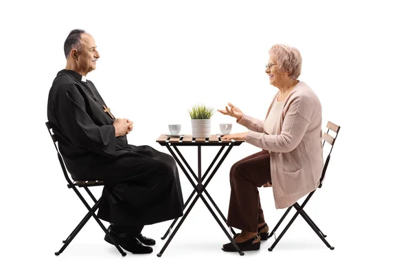 Sacerdote Una Anciana Sentados Una Mesa Con Café Hablando Aislados — Foto de Stock