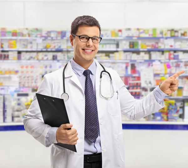 Young Male Chemist Clipboard Pointing Pharmacy — Stock Photo, Image