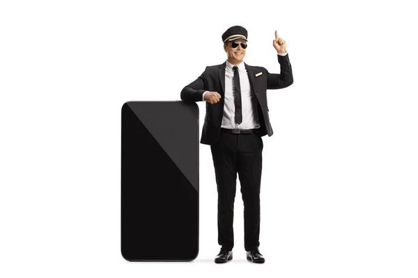 Chauffeur Leaning Big Mobile Phone Pointing Isolated White Background — Stock Photo, Image