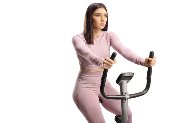 Jonge Fitte Vrouw Sportkleding Een Stationaire Fiets Geïsoleerd Witte Achtergrond — Stockfoto