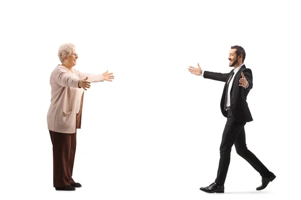 Full Length Profile Shot Businessman Walking Older Woman Arms Wide — Zdjęcie stockowe