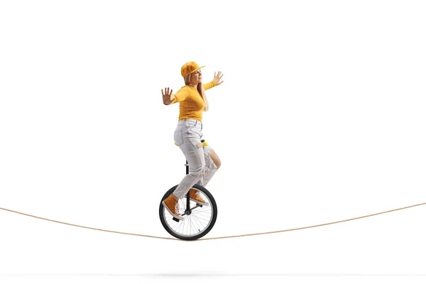 Full Length Side Shot Young Female Riding Unicycle Tightrope Isolated — 스톡 사진