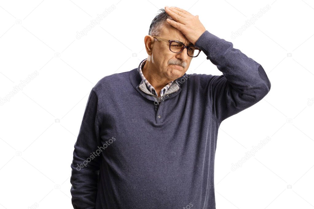 Upset mature man holding his forhead isolated on white background