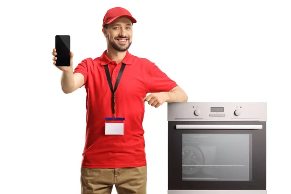 Male Shop Assistant Oven Smiling Showing Smartphone Isolated White Background — стоковое фото