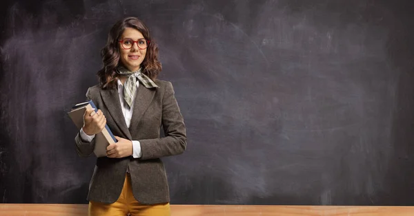 Young Female Teacher Holding Books Posing Front Chalkboard — Stock Photo, Image