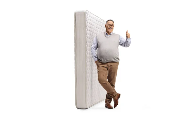 Mature Man Posing Next Bed Mattress Gesturing Thumb Sign Isolated — Foto de Stock