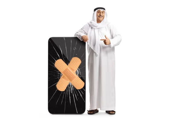 Arab Man Ethnic Clothes Leaning Big Smartphone Bandage Strip Pointing — ストック写真