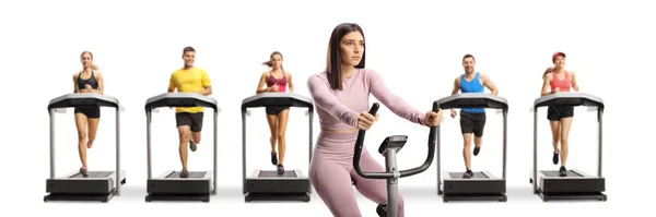 Young Fit Woman Sportswear Exercising Stationary Bike People Running Treadmills — Fotografie, imagine de stoc