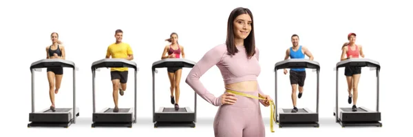 Young Fit Woman Sportswear Measuring Her Waist People Running Treadmills — Zdjęcie stockowe