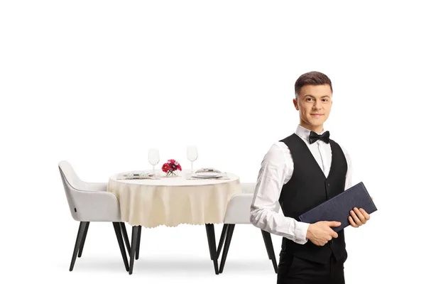 Young Waiter Bow Tie Standing Front Table Holding Menu Isolated — Stockfoto