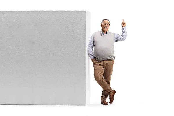 Full Length Portrait Mature Man Leaning Wall Pointing Isolated White — Photo