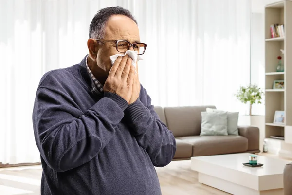 Mature Man Blowing Nose Paper Tissue Home Living Room — стоковое фото