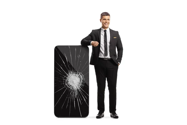 Man Black Suit Tie Leaning Big Smartphone Broken Screen Isolated — Fotografia de Stock