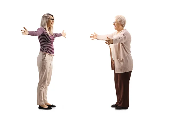 Full Length Profile Shot Young Woman Meeting Elderly Woman Arms — Foto Stock