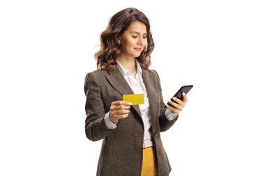 Young woman using a smrtphone and holding a credit card isolated on white background