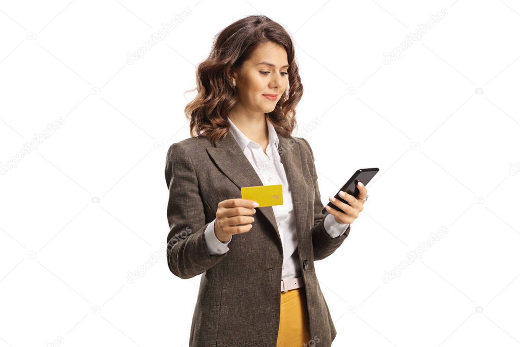 Young woman using a smrtphone and holding a credit card isolated on white background