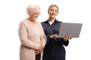 Female worker looking at a laptop computer with an elderly woman isolated on white background