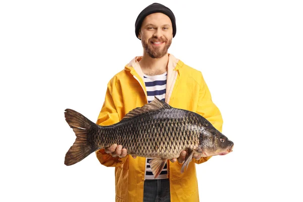 Young Fisherman Yellow Raincoat Holding Big Carp Fish Smiling Isolated — Stock fotografie