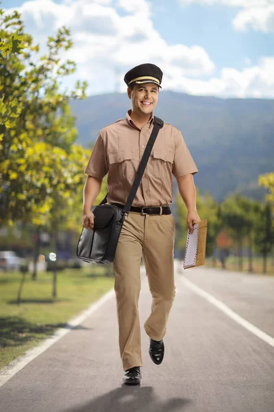 Full Length Portrait Mailman Walking Camera Carrying Bag Letter Outdoors — Stock Photo, Image