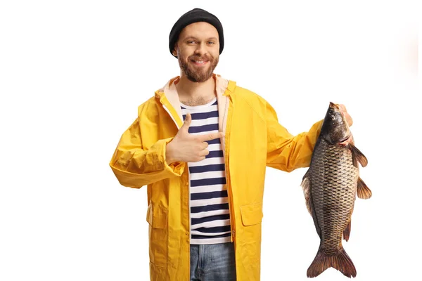 Young Fisherman Yellow Raincoat Holding Carp Fish Pointing Isolated White — Stock Photo, Image