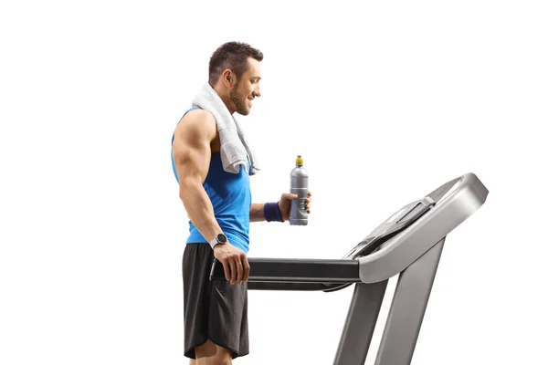 Young Man Standing Treadmill Bottle Isotonic Drink Isolated White Background — Stock Photo, Image